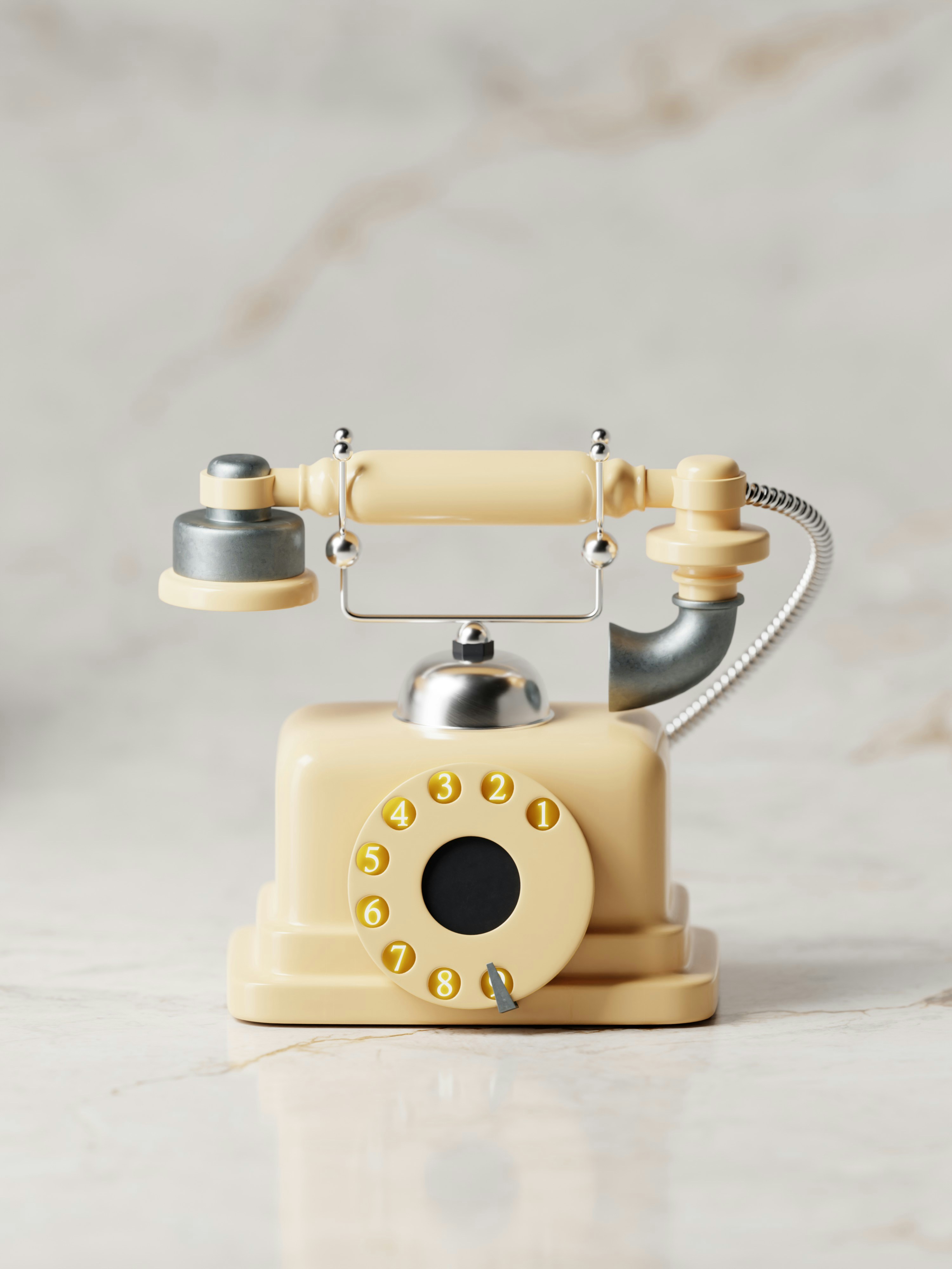 A cream colored antique telephone